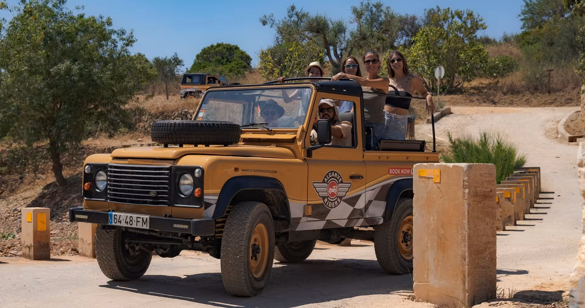 Friends enjoy an open-top jeep safari through Algarve vineyards and countryside on The Wine & Nature Escape tour