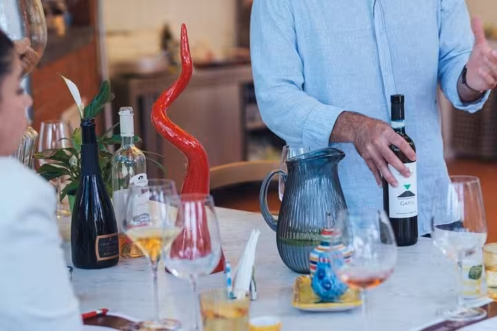 An assortment of wine bottles and glasses on a table during a wine tasting event in Sorrento.
