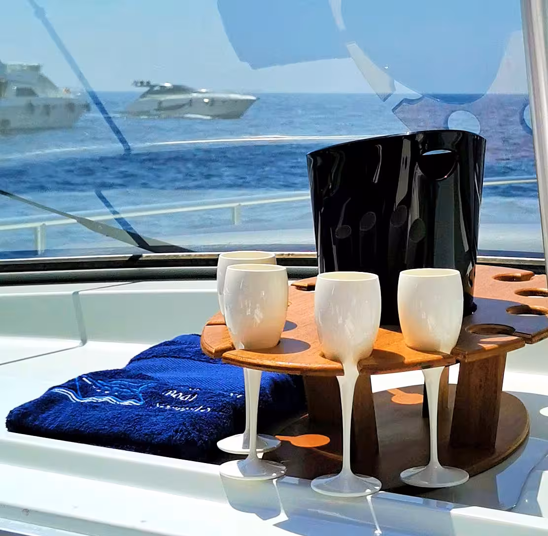 Elegant wine set on yacht with sea view, perfect for exclusive Capri boat tour from Sorrento experience.