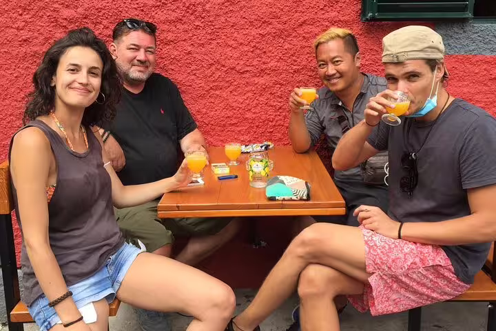 Group enjoying wine tasting and refreshments at an outdoor table during a bestselling 4x4 adventure wine tour experience.