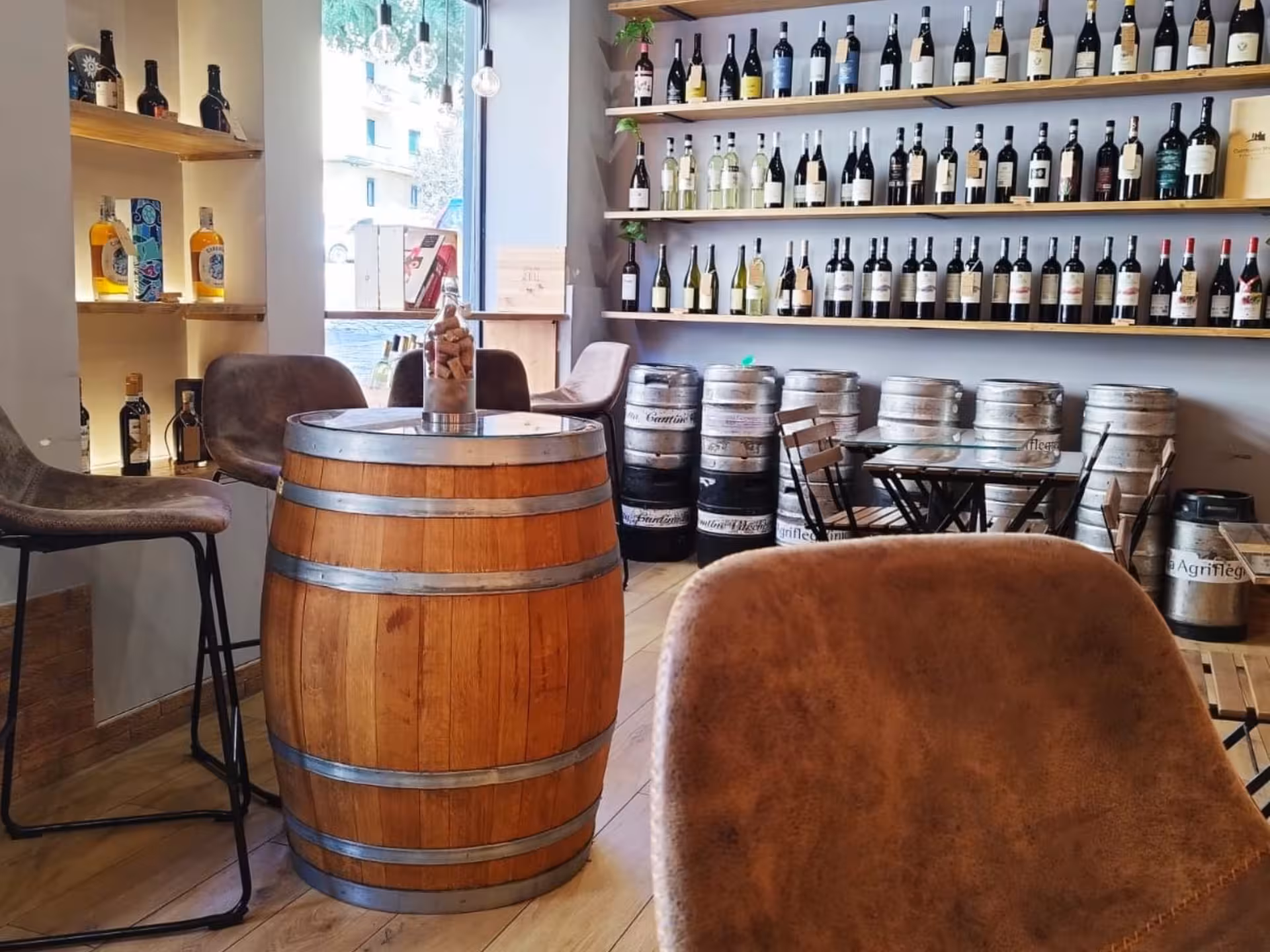 Charming wine bar in Naples with barrel tables and an extensive selection of wines for tasting adventures.