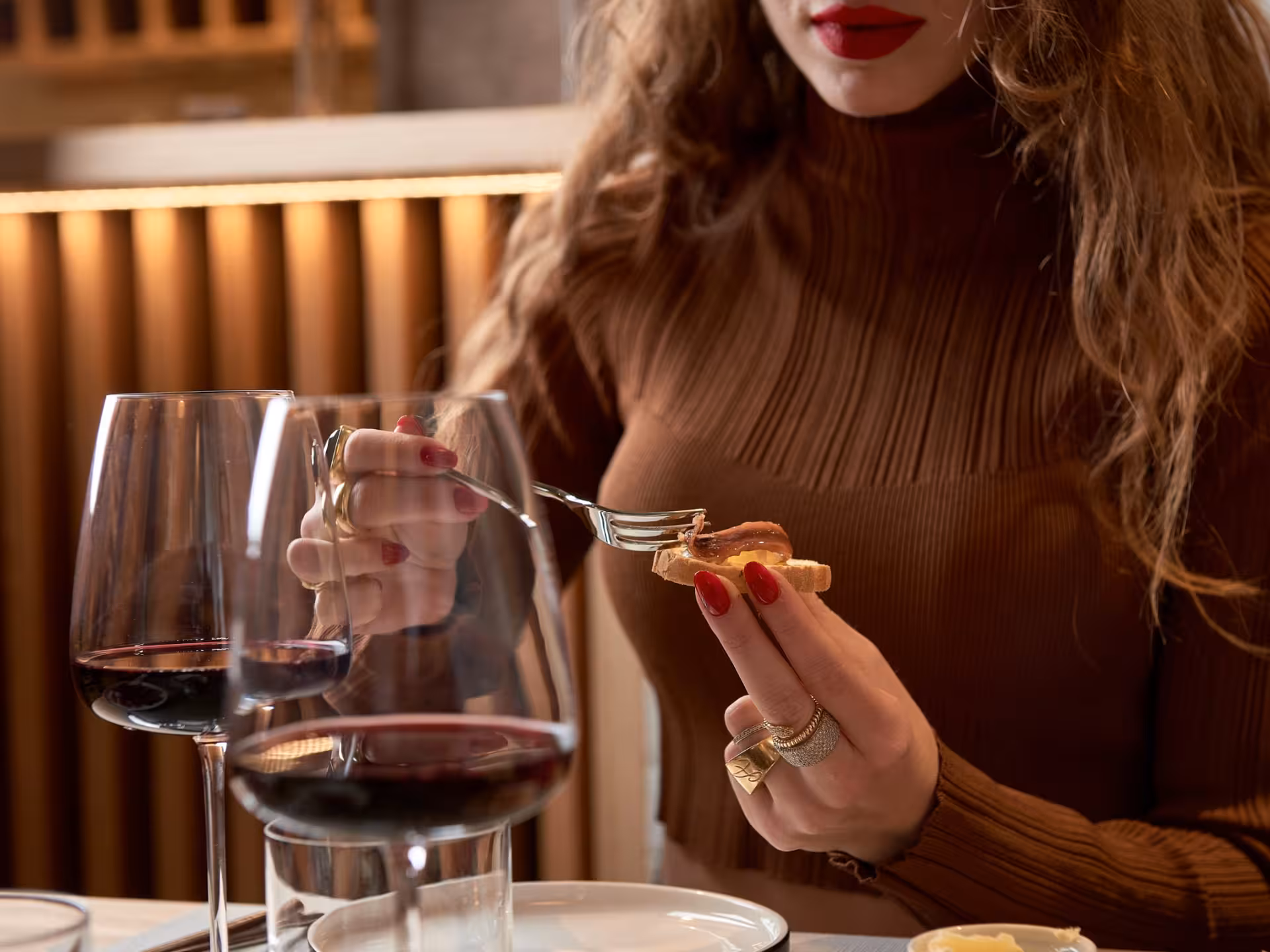 Woman enjoying a wine tasting with gourmet food pairing in Bari City Center, highlighting Italian culinary culture.