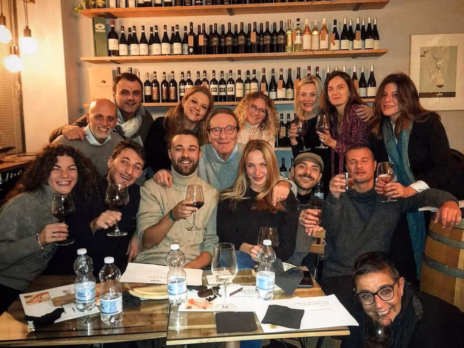 Group enjoying wine tasting with local food pairings in a cozy Naples wine bar, showcasing camaraderie and culture.