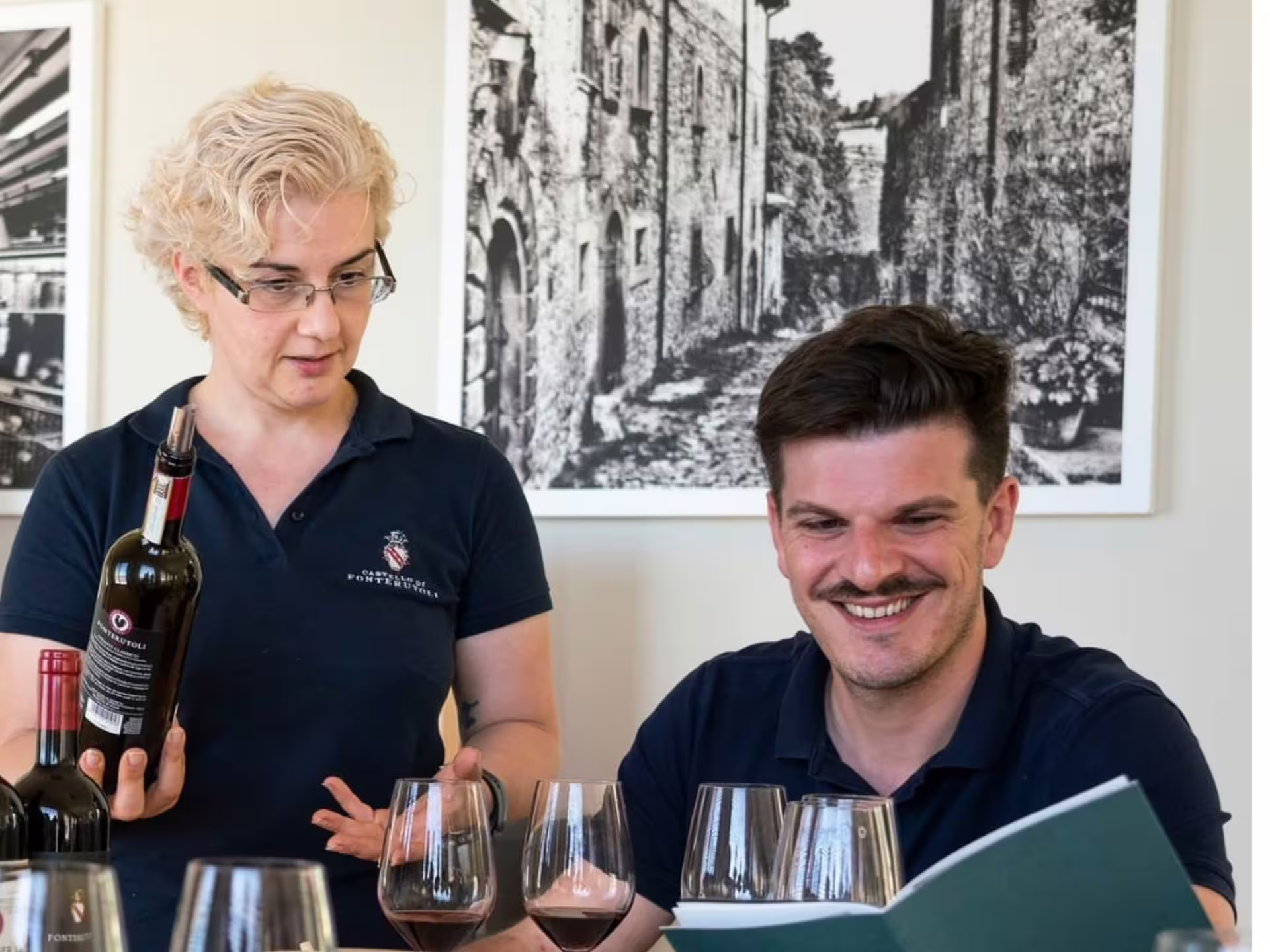 Wine expert introducing a selection of wines to a guest during a tasting session near Grosseto.