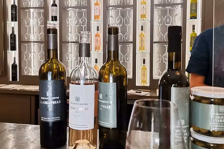 Wine tasting in Provence with local bottles and glasses, part of Baux and Saint Rémy de Provence tour