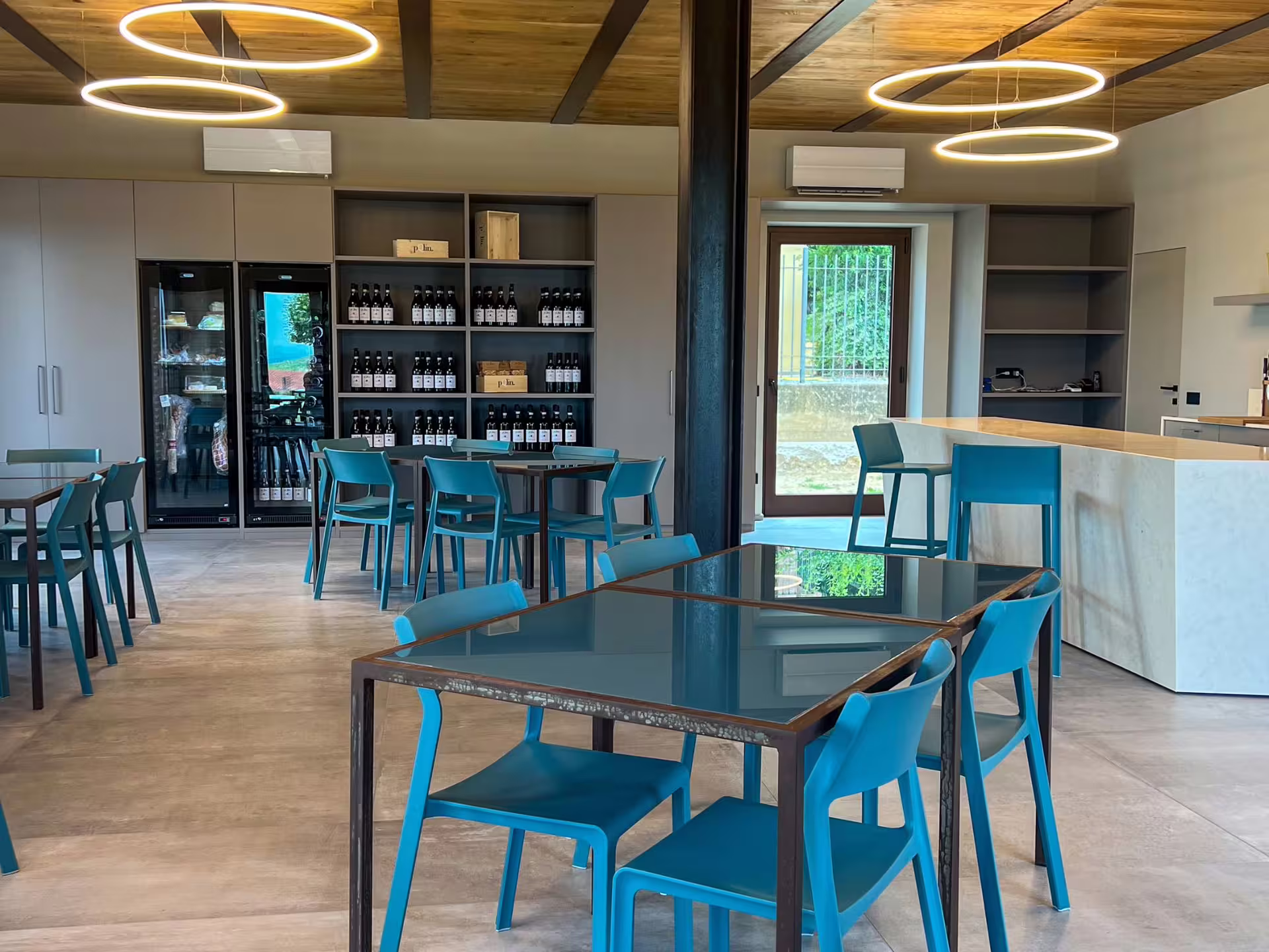 Modern wine tasting room in Langhe with tables and wine displays, ideal for food pairings near Alba.