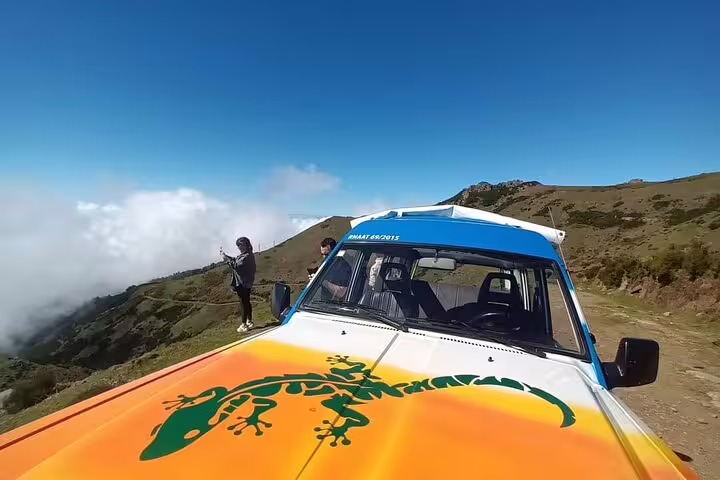 4x4 adventure vehicle on a scenic hilltop during bestselling wine tour, with tourists enjoying panoramic views and skywalk experience.