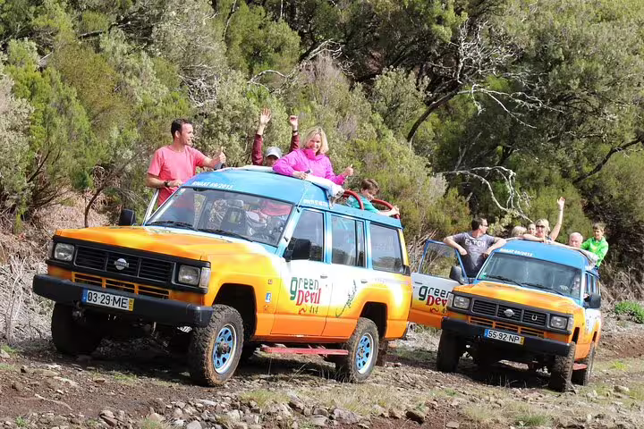 Tourists enjoying a thrilling 4x4 adventure through lush landscapes, part of a bestselling wine tour with tasting and skywalk experience.