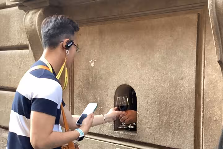 Experience the unique tradition of receiving wine through a wine window on the Wine Windows Walk in Italy.