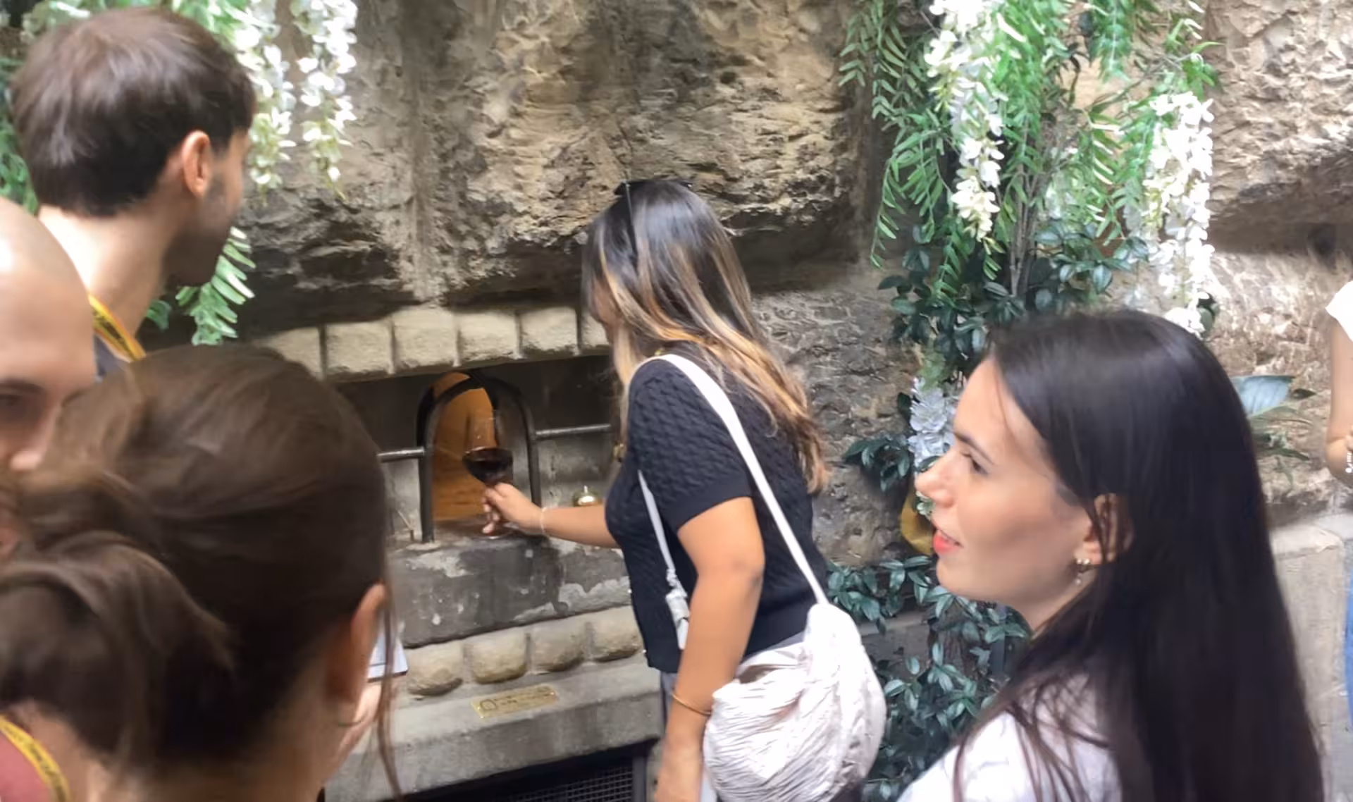 Participants receiving wine through a traditional wine window on the Wine Windows Walk.