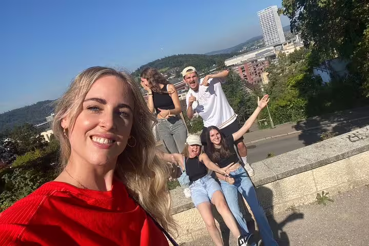 Group selfie at a Winterthur overlook with skyline views, enjoying a self-guided scavenger hunt and sights tour