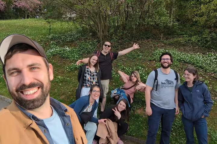 Group smiles in a park on the Winterthur scavenger hunt and sights self-guided walking tour adventure