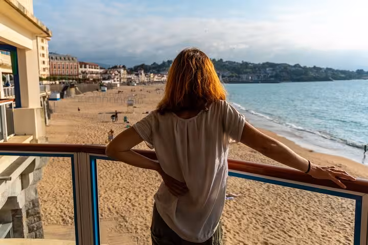 Woman enjoying a scenic view of Biarritz beach during a private 2-hour city walk with a local guide.