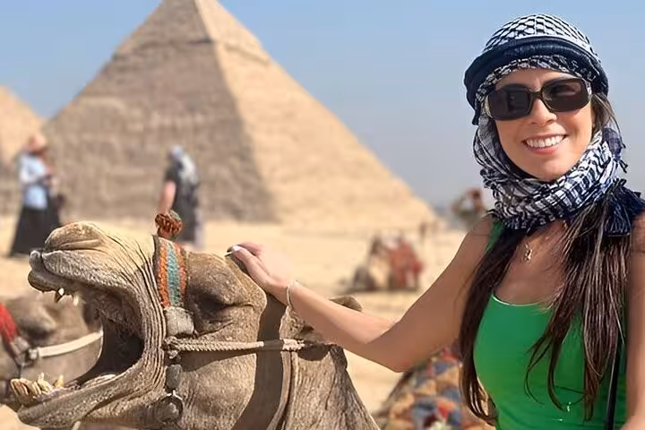 Woman with camel at Giza Pyramids on a half-day tour to the Great Pyramids and Sphinx with lunch included