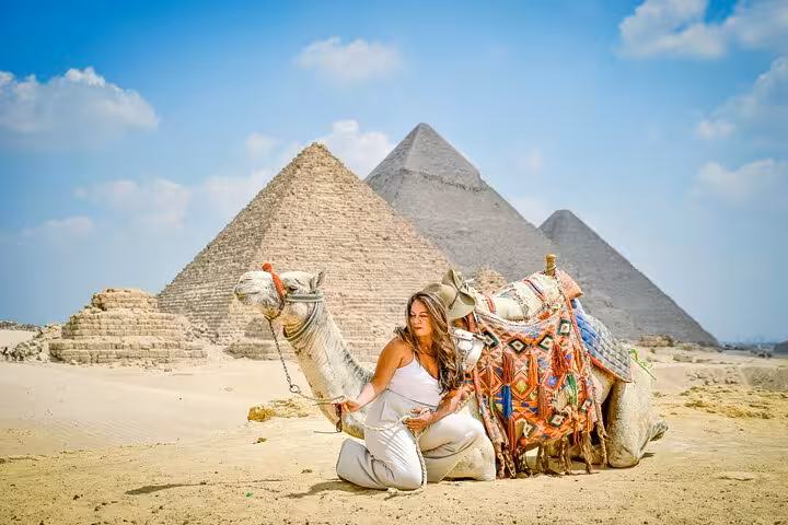 Woman with camel at the Pyramids of Giza on a Cairo day tour by plane from Marsa Alam, Egypt excursion