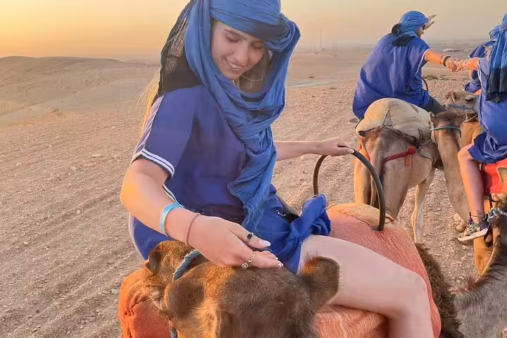 Woman on camel at sunset in Agafay Desert Marrakech, quad biking and camel tour with dinner show package