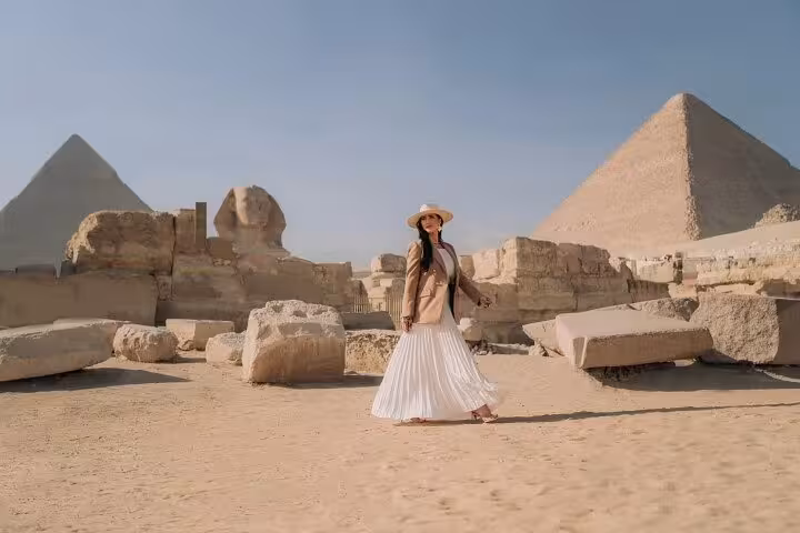 Woman walking among ruins near the Great Sphinx and Giza Pyramids on a half-day private tour with guide