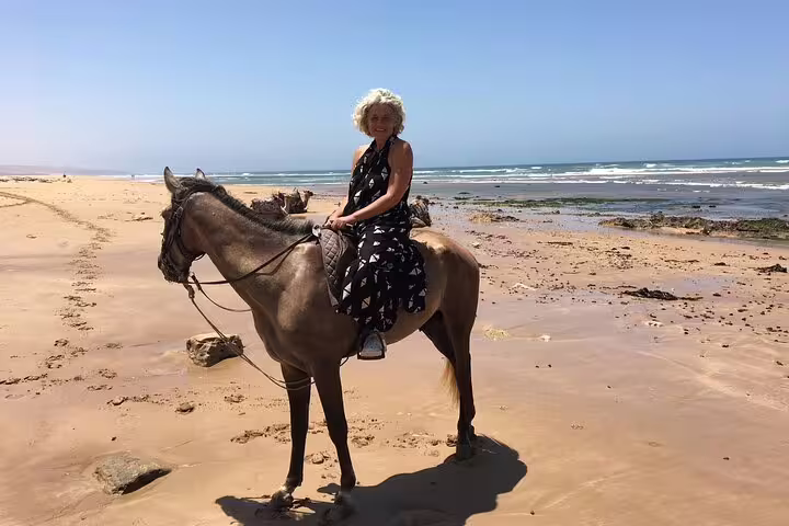 Woman horseback riding on Morocco’s Atlantic beach, a highlight of the 3-day Marrakech ocean escape tour