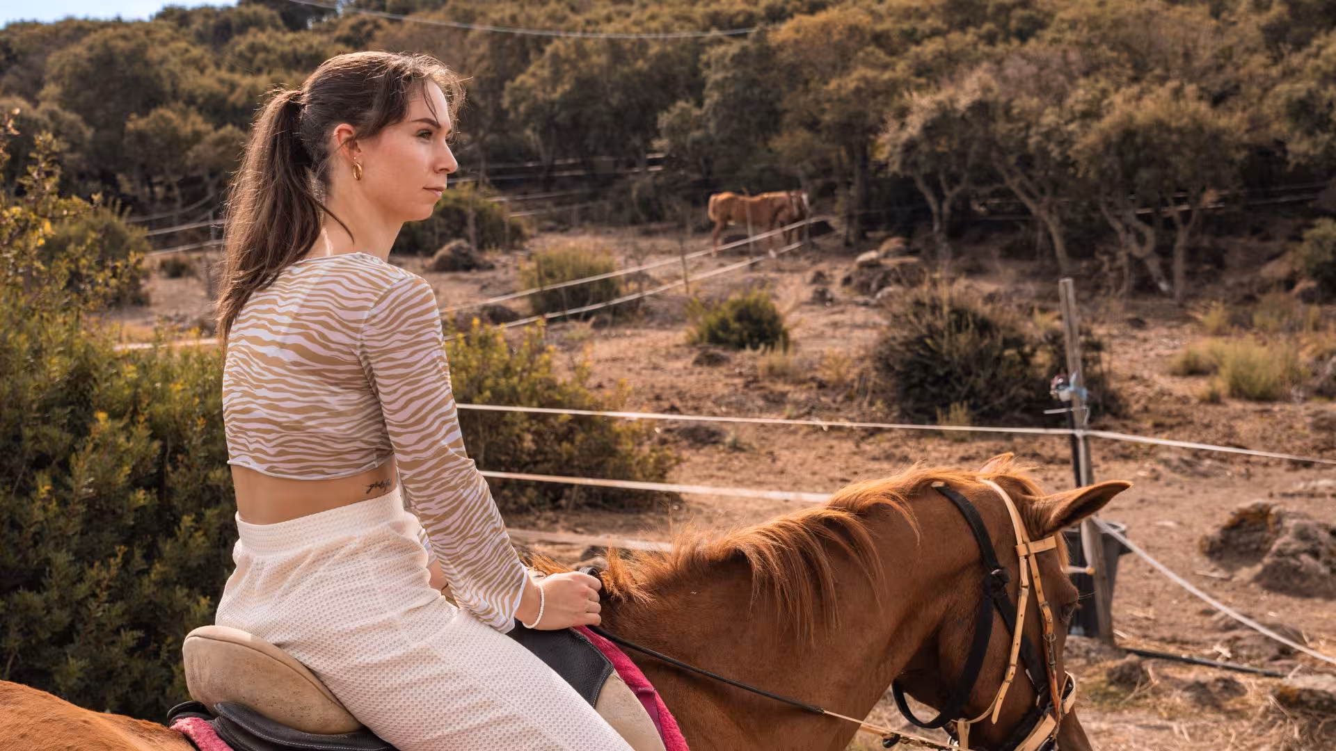 Woman enjoying horseback riding in Sedini's serene countryside, a tranquil escape near Castelsardo.