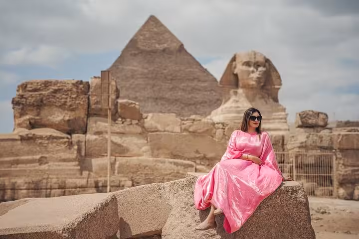 Woman in pink dress at Great Sphinx and Pyramid of Khafre on private Giza tour, Cairo Egypt sightseeing