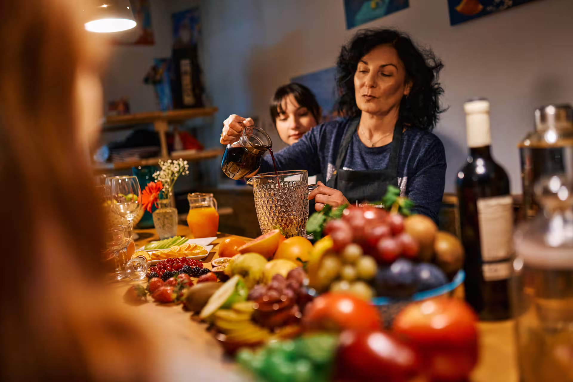 Woman preparing ingredients for a vibrant paella cooking class, surrounded by fresh fruits and drinks, enhancing the culinary experience.