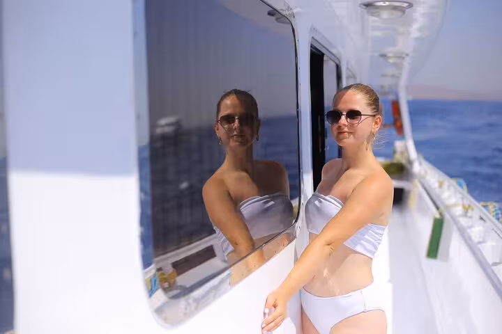 Woman relaxing on yacht deck during Sharm El Sheikh day sail to White Island and Ras Mohamed National Park