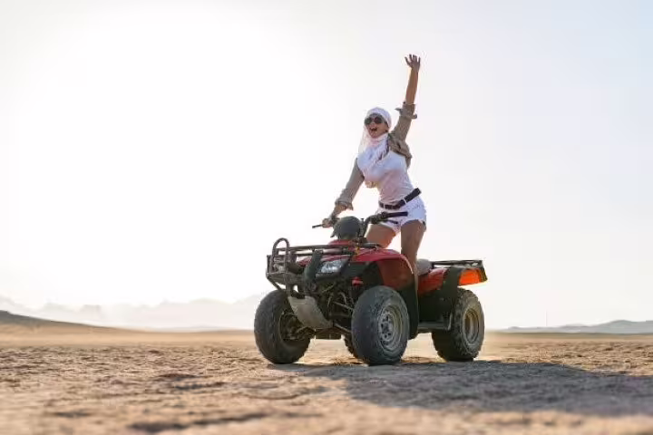 Woman riding ATV quad bike in Sinai Desert on private safari adventure tour from Sharm El Sheikh