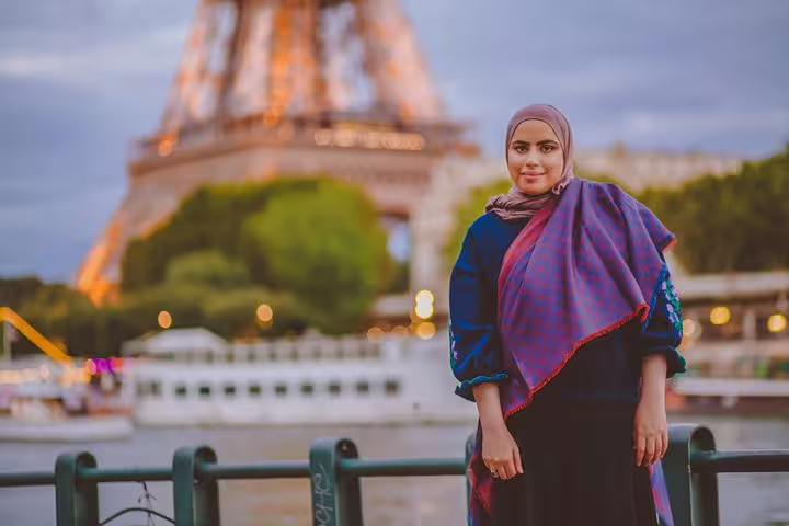 Woman posing by the Seine with Eiffel Tower at dusk, shot on a private Paris travel photographer walking tour