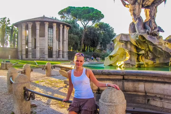 Woman enjoying the scenic view at Temple of Hercules and Fountain of Tritons on a private Rome kickstart tour for newcomers.