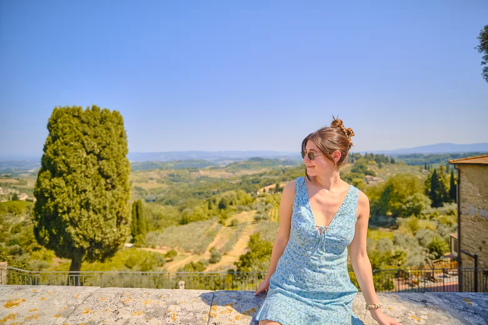 Woman enjoying a scenic view of the Tuscan countryside on a Pisa, Siena, and San Gimignano day trip.