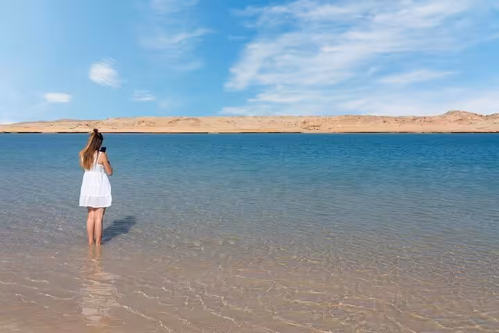 Woman wading in clear Ras Mohamed lagoon near Sharm El-Sheikh, scenic Red Sea stop on half-day tour