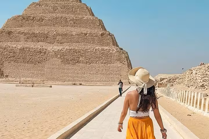 Woman walking toward Saqqara Step Pyramid, part of Giza Pyramids Saqqara Memphis full-day tour