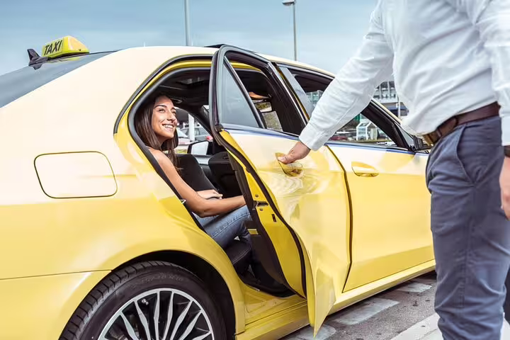 Smiling woman entering a yellow taxi, beginning her private day trip from Rome to Tivoli with convenient transport.