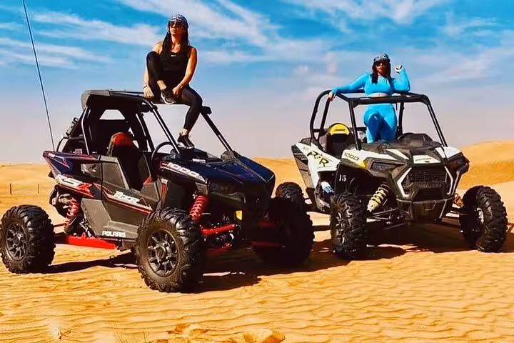 Women posing on off-road buggies in the Sinai Desert, Sharm El Sheikh buggy safari with thrilling dune ride views