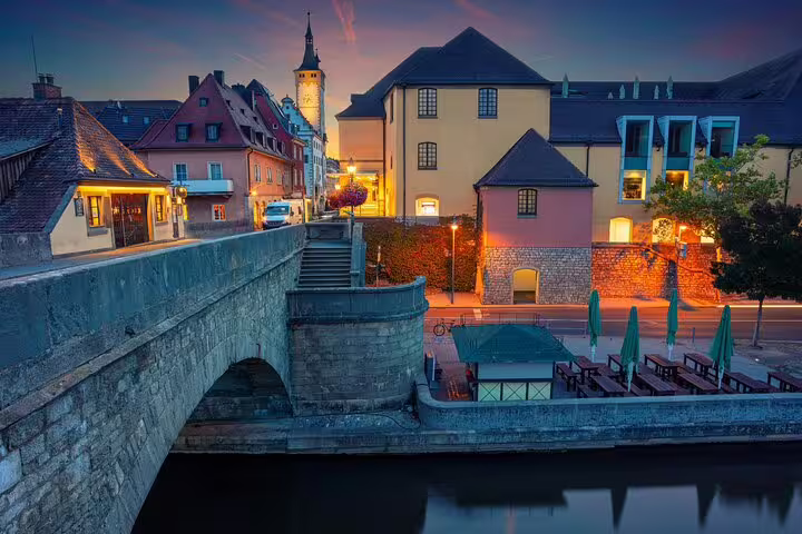 Evening view of Würzburg riverside and Old Main Bridge, scenic waypoint on a self-guided scavenger hunt tour