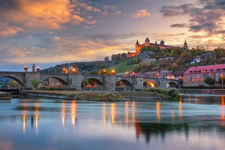 Old Main Bridge at sunset with Marienberg Fortress, scenic clue stop on Würzburg self-guided scavenger hunt