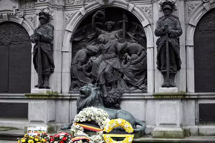 WWI memorial statue in Ypres with wreaths, a key stop on the Ypres e-scavenger hunt self-guided walk