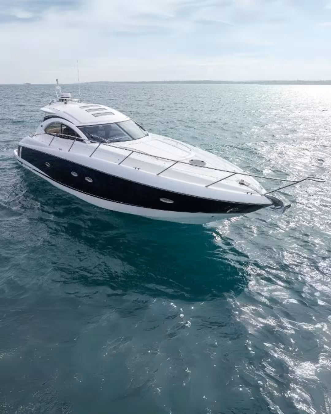 XCLUSIVE III Private Luxury Yacht cruising across clear turquoise Arabian Gulf waters on a premium Dubai charter