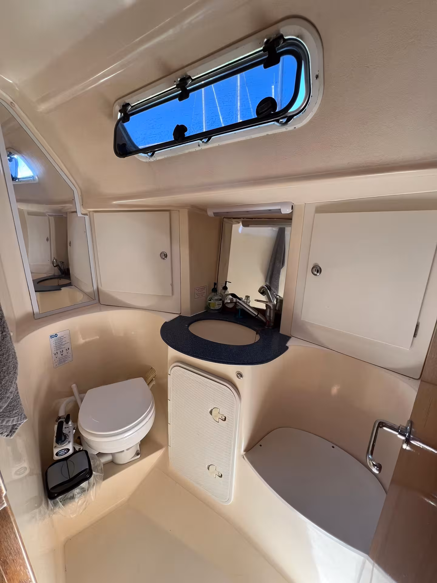 Clean onboard yacht bathroom with toilet and sink, comfort on Lagos Algarve elegant yacht sunset tour