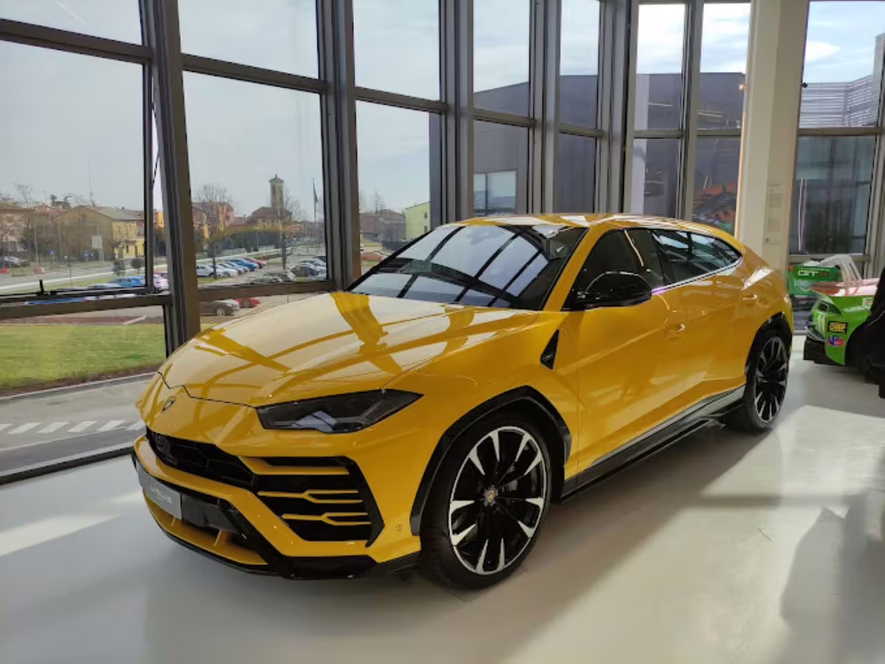 Vibrant yellow Lamborghini SUV showcased in Museo Lamborghini, emphasizing luxury and performance.
