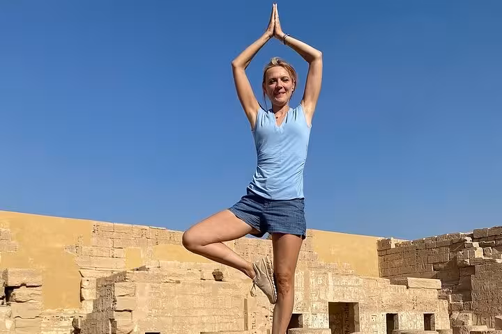 Experience serenity with a yoga pose amidst historic temple ruins on a Luxor West Bank private day tour.