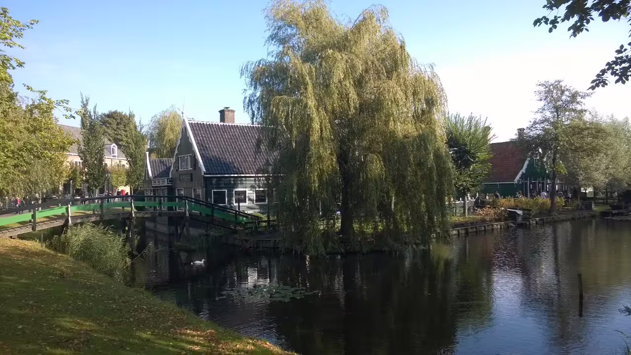 Canal view with wooden bridge and historic houses in Zaanse Schans, a scenic private tour from Amsterdam
