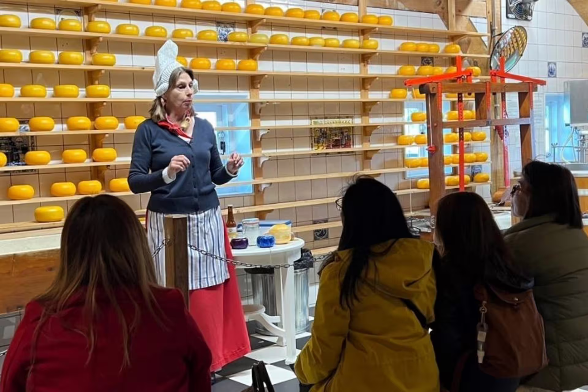 Zaanse Schans cheese farm demonstration near Amsterdam, guide presenting Gouda tasting on day tour