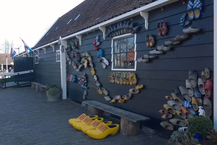 Zaanse Schans clog workshop wall display with colorful wooden shoes on Amsterdam half-day small-group tour