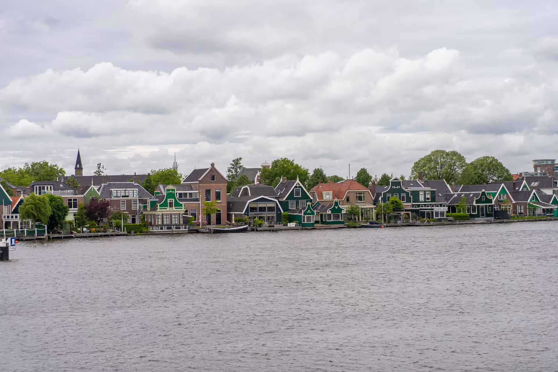 Panoramic Zaanse Schans riverside village with traditional Dutch gabled houses, scenic stop on 1-day walking tour