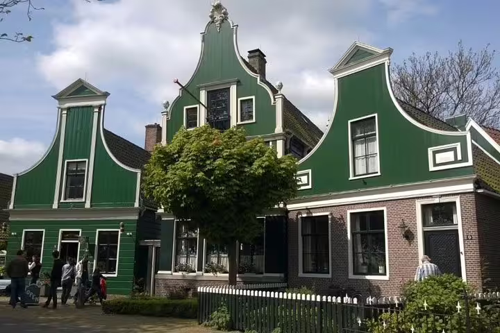 Green gabled houses in Zaanse Schans village on a small-group half-day tour from Amsterdam, Netherlands