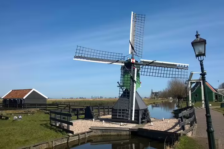 Traditional Dutch windmill by canal at Zaanse Schans, visited on a small-group half-day tour from Amsterdam