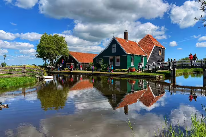 Zaanse Schans canal view with historic windmill village houses and bridge on a private half-day tour