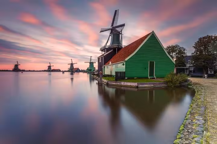 Zaanse Schans windmill and green house at sunset on a private Volendam tour, classic Dutch heritage view