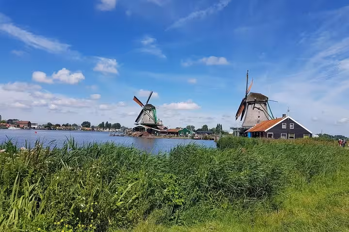 Zaanse Schans windmills across the river near Amsterdam, scenic countryside stop on the city and countryside tour